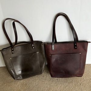 2 Portland leather totes. Zipper closure. 1 inside & 1 outside pocket.